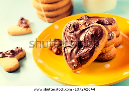 Selective focus on the front round cookie with melting chocolate on plate