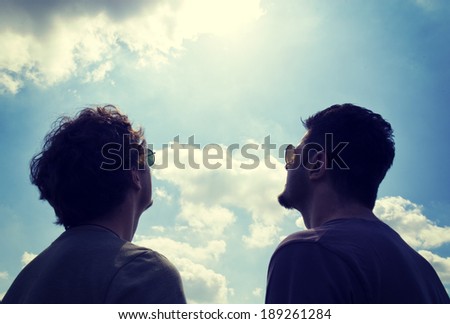 Two man watching on the sky and sun