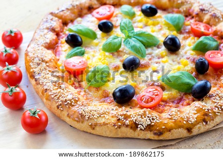 Juicy vegetarian pizza with cheese and vegetables.Selective focus on the front part of pizza