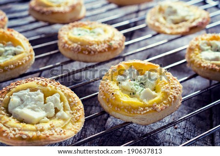 Fresh baked pastry with melting cheese on top.Selective focus on pastry in the middle
