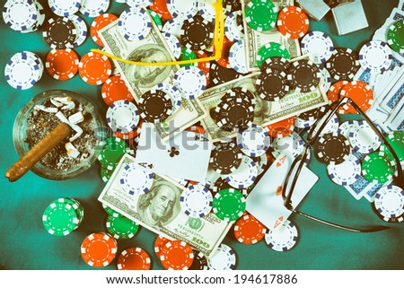 Bunch of the poker chips and money from above on table