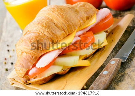 Fresh baked French croissant sandwich.Selective focus on the front part of sandwich