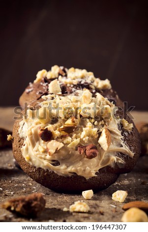 Selective focus on the cookie with sweet white chocolate cream and nuts