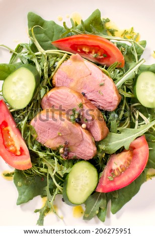 Juicy meat and vegetables in the plate from above