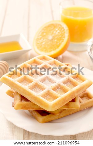 Traditional Belgium waffles and orange juice.Selective focus on the waffles
