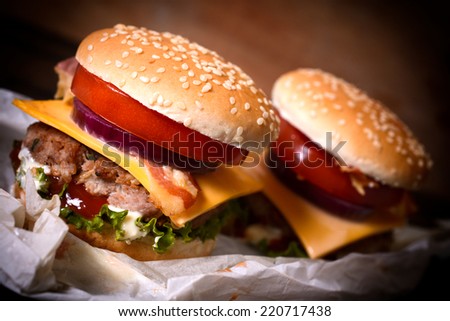 Juicy mini cheeseburgers with bacon and vegetables,selective focus