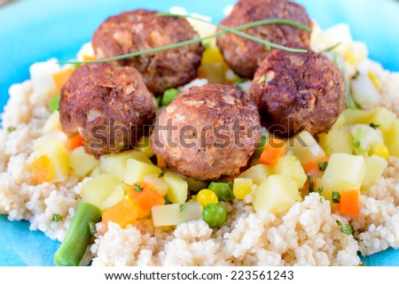 Juicy beef meat balls and couscous in the plate,selective focus