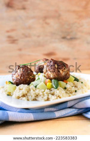 Meat balls with couscous in the plate,selective focus and blank space above