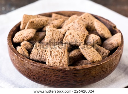 Sweet chocolate pillows in wooden bowl,selective focus