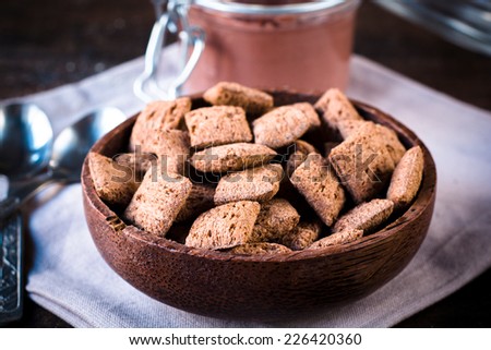 Sweet chocolate pillows in wooden bowl,selective focus