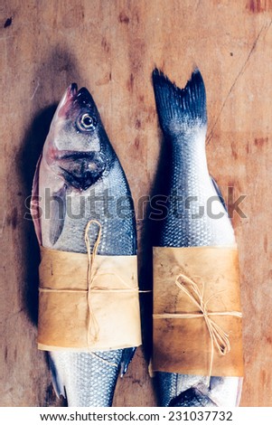 Sea bass fish raw on the wooden background