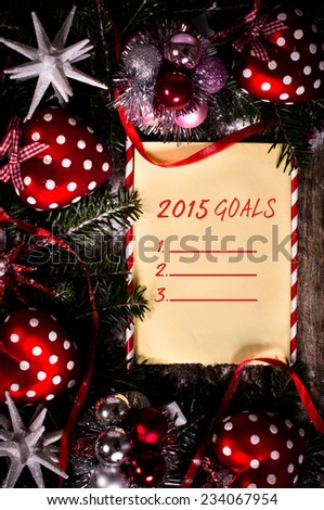2015 Goals paper in the middle of Christmas decorations on wooden background