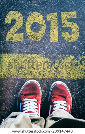 Mans legs behind the yellow line from above with 2015 sig