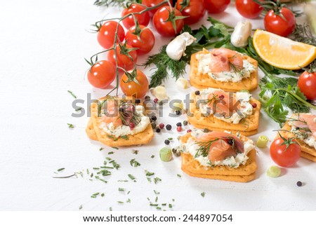 Little salmon crackers sandwiches with creamy cheese,selective focus