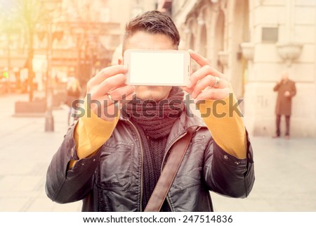 Man holding telephone with blank screen and make selfie