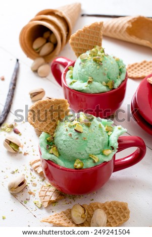 Pistachio flavor ice cream in the cups.Selective focus on the front ice cream