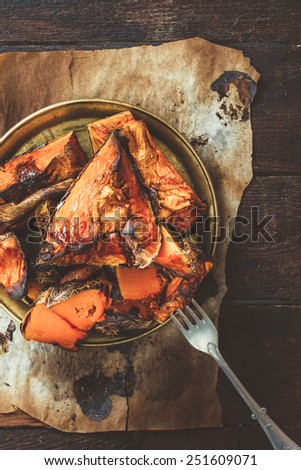 Sweet grilled pumpkin in the plate on wooden background