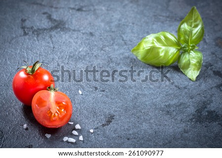 Slice cherry tomato on dark board with blank space,selective focus
