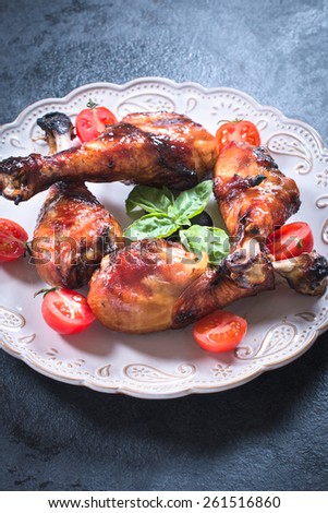 Chicken legs with honey and spices in the plate,selective focus