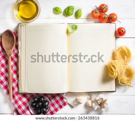 Blank recipe cooking book and ingredients on white table,selective focus and above