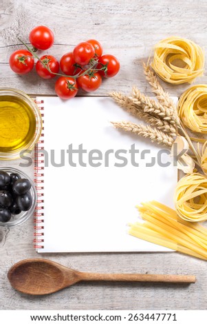 Italian traditional pastas and ingredients with blank cooking book