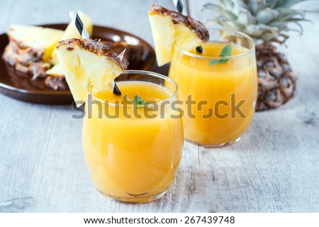 Fresh pineapple juice in the glass,selective focus