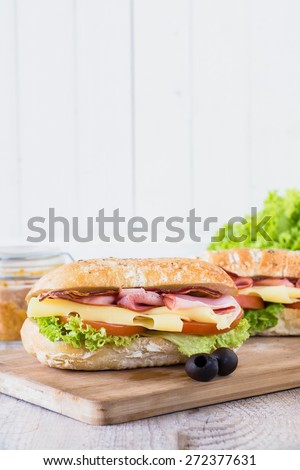 Ciabatta sandwich with bacon and cheese from above,selective focus and blank space