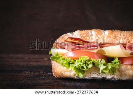 Ciabatta sandwich on wooden background with blank space gor the text
