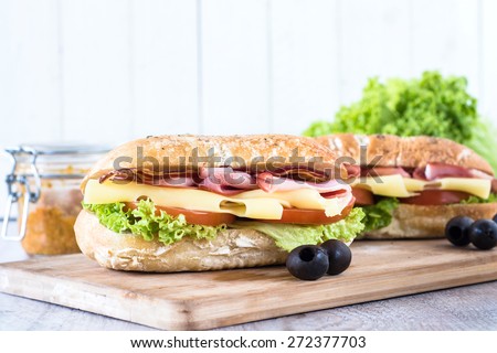 Ciabatta sandwich with bacon and cheese on wooden boarde,selective focus and blank space