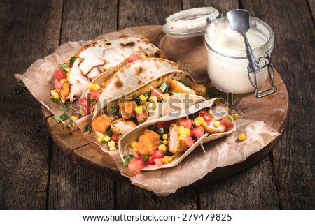 Tortilla bread sandwiches stuffed with fried chicken and vegetables