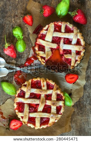 Two homemade and baked tart cakes stuffed with strawberries sauce,selective focus