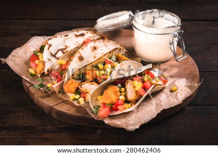 Traditional Mexican tortilla sandwiches with fried chicken meat and vegetables,selective focus