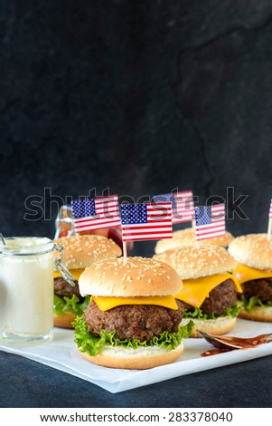 American mini beef burgers with cheese and USA flags,selective focus and blank space