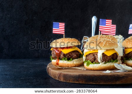 Ground beef mini burgers on wooden board,selective focus and blank space