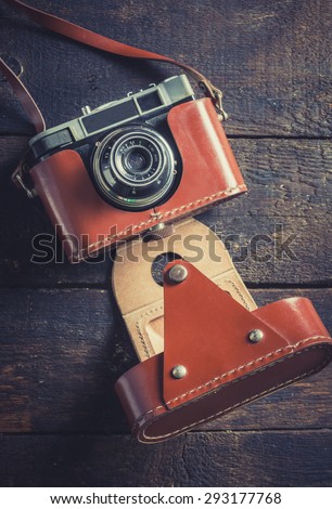 Old film camera on wooden background