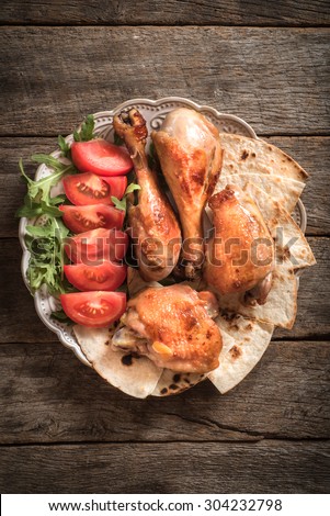 Chicken meat and tortilla bread in the plate,from above on wooden background