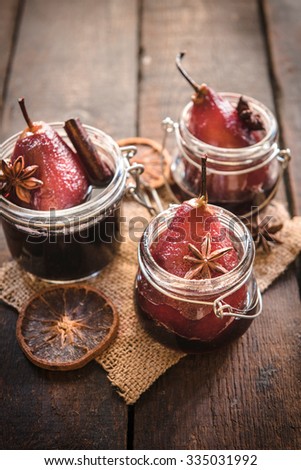 Pears cooked in the red wine served in jars,selective focus