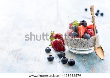 Homemade chia pudding with berry fruit in the glasses,selective focus and empty space