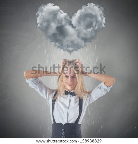 Cloud raining heart shape on top of sad Crying stressed unhappy Woman