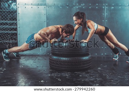 Sportswoman. Fit sporty woman doing push ups on tire strength power training concept crossfit fitness workout sport and lifestyle