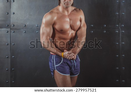 Bodybuilder posing Strong Athletic Man Fitness Model Torso showing big muscles fitness healthy lifestyle bodybuilding concept