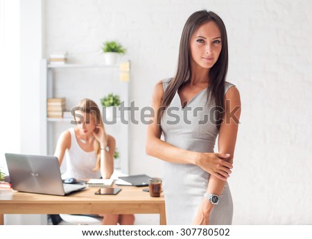 Pretty businesswoman looking at camera and smiling
