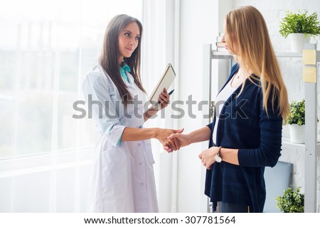 Woman medical doctor shaking hands with patient concept  healthcare, medical, hospital