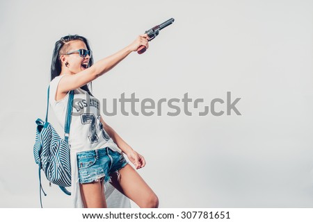 Fashion swag sexy girl holding gun woman having fun  hooligan, rebel
