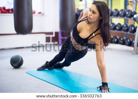 Fit woman doing side plank yoga pose Concept pilates fitness healthy lifestyle.