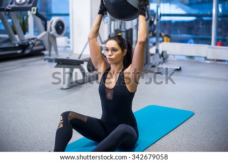 Work out fitness woman doing sit ups abs abdominal crunches exercises with ball