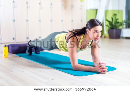 fitness training athletic sporty woman doing plank exercise in gym or yoga class concept exercising workout aerobic