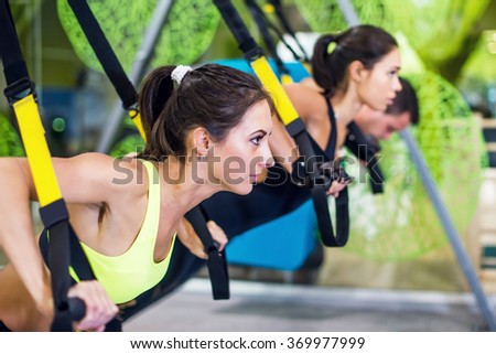 People at gym doing elastic rope exercises Concept sport workout fitness healthy lifestyle.