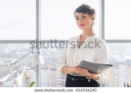 http://image.shutterstock.com/display_pic_with_logo/950635/416926240/stock-photo-close-up-portrait-of-a-young-confident-female-office-manager-at-her-workplace-ready-for-doing-416926240.jpg