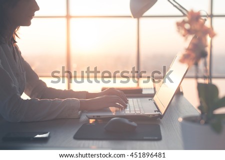 Adult businesswoman working at home using computer, studying business ideas on a pc screen